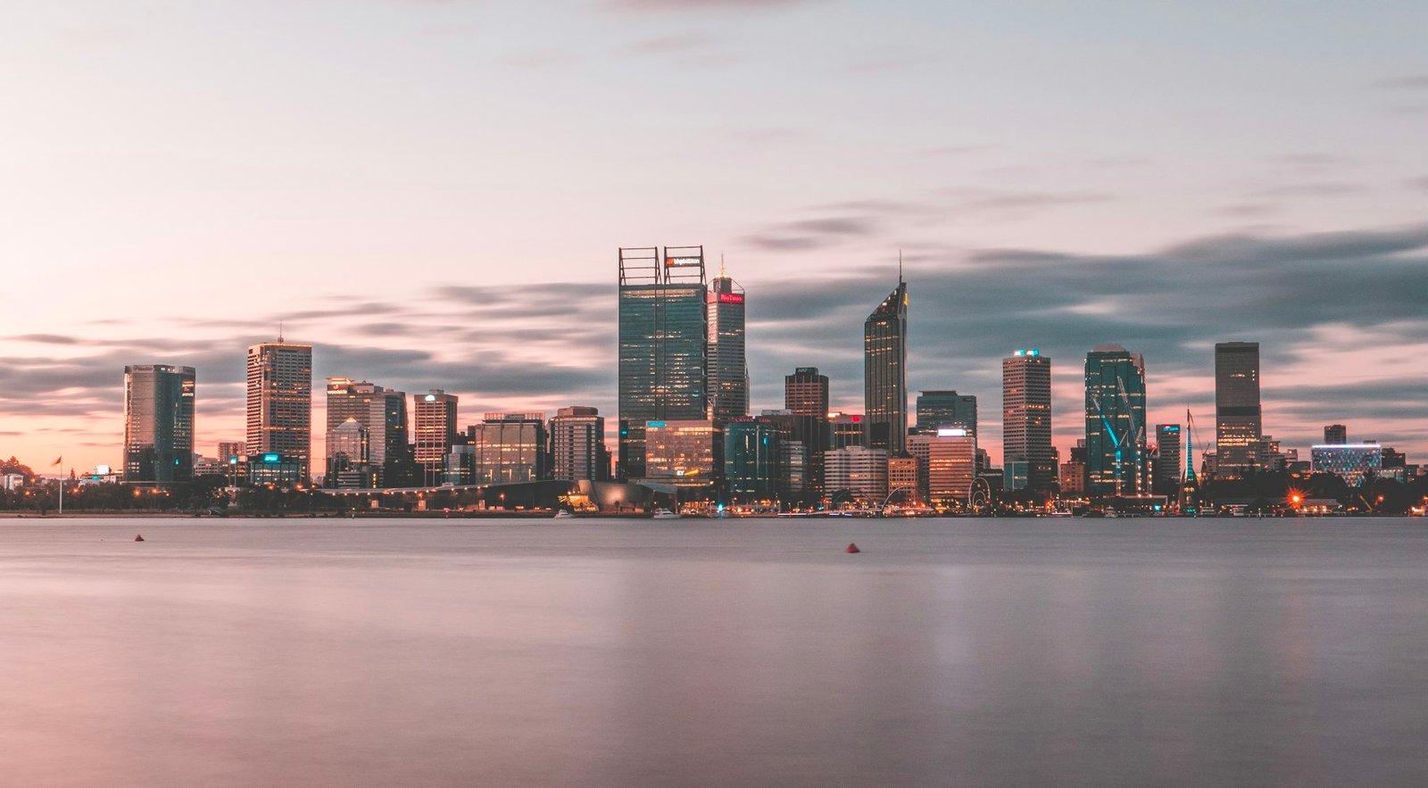Perth city skyline at sunset across the Swan River